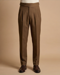 Brown pleated pants on a beige background